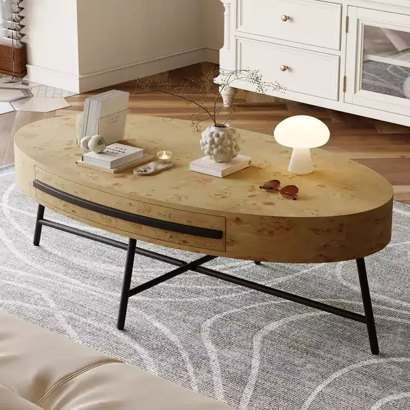 Oval coffee table with drawers, 47.2inches in diameter, featuring storage and cross-shaped metal legs; unique curved design, suitable for living room