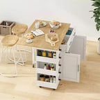 Desserte îlot de cuisine blanche avec placard à 2 portes et 2 tiroirs - Chariot de rangement roulant avec plateau pliant en bois d'hévéa, étagère à épices et casier à vin pour la cuisine